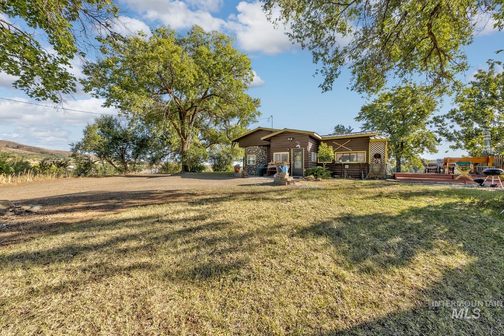 View of green lawn featuring a deck