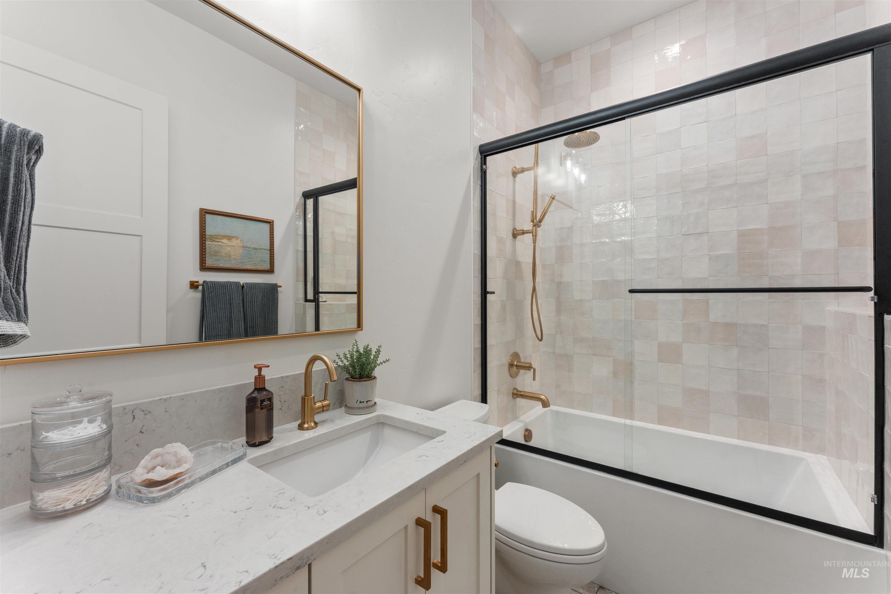 Full bathroom with vanity and shower / bath combination with glass door