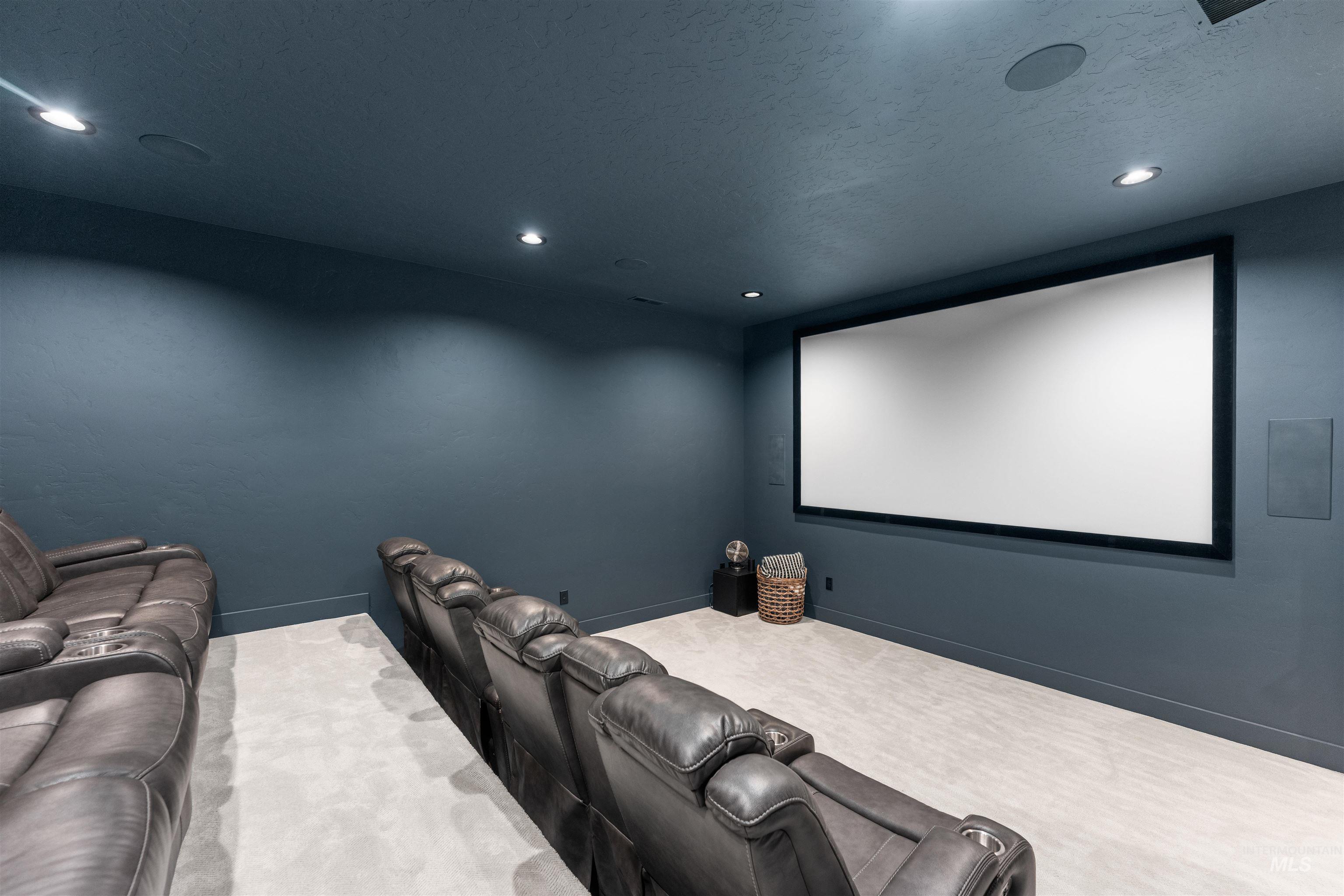 Carpeted cinema room featuring recessed lighting and a textured ceiling