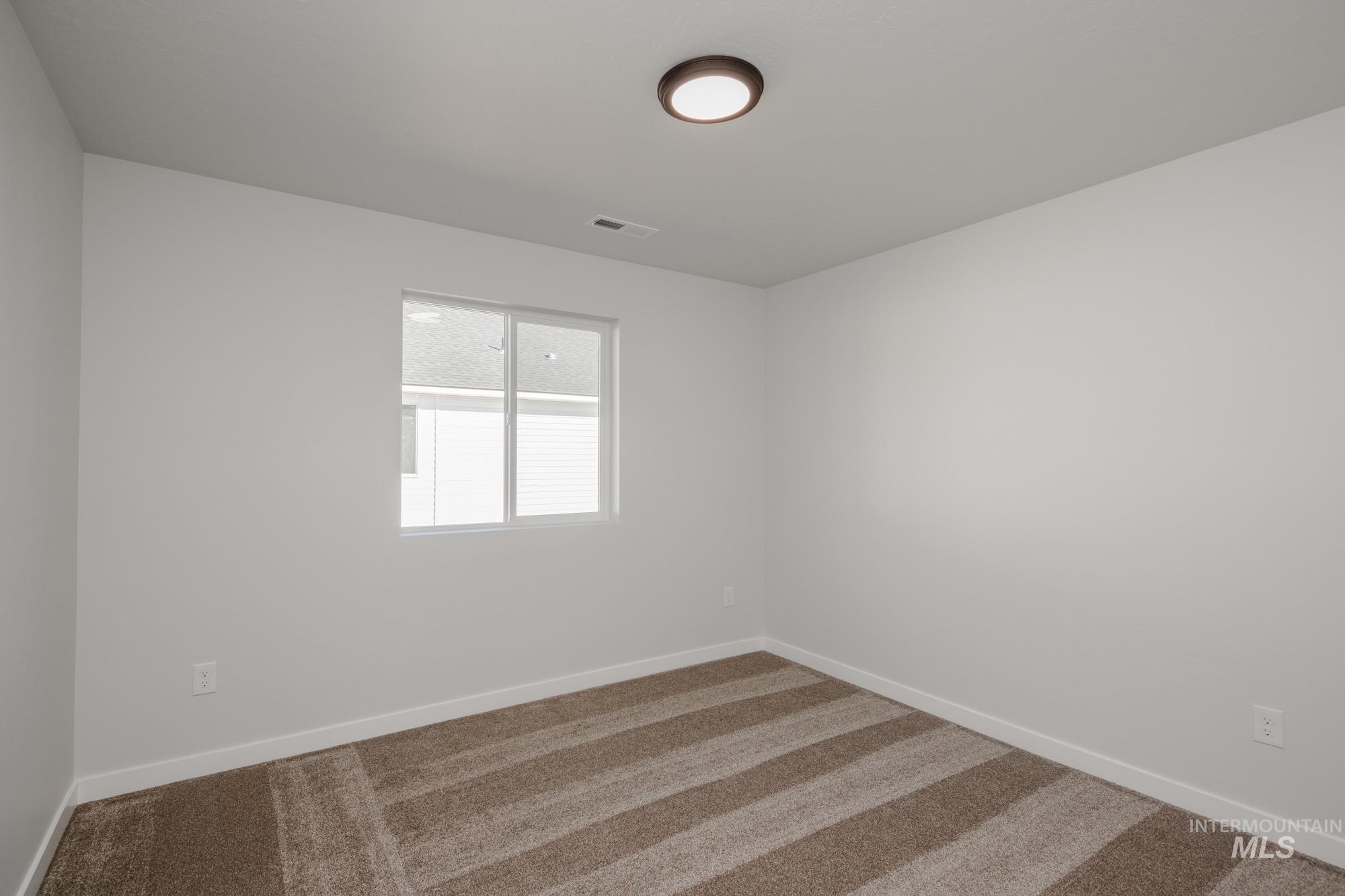 Unfurnished room with carpet floors and baseboards