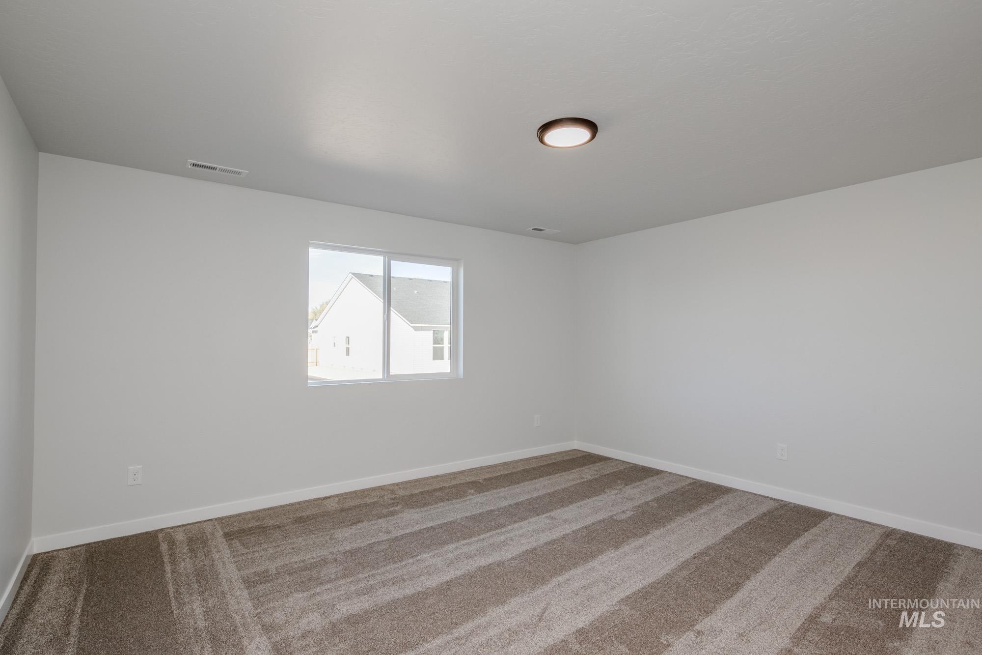 Spare room with carpet floors and baseboards