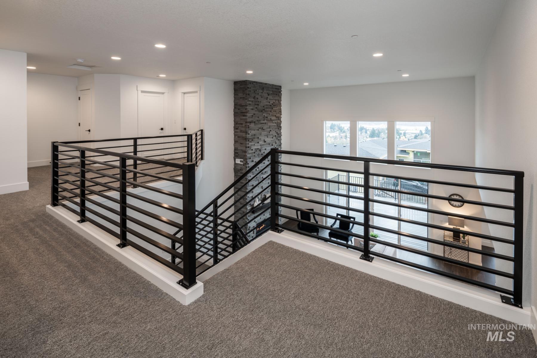 Hall featuring carpet, an upstairs landing, and recessed lighting