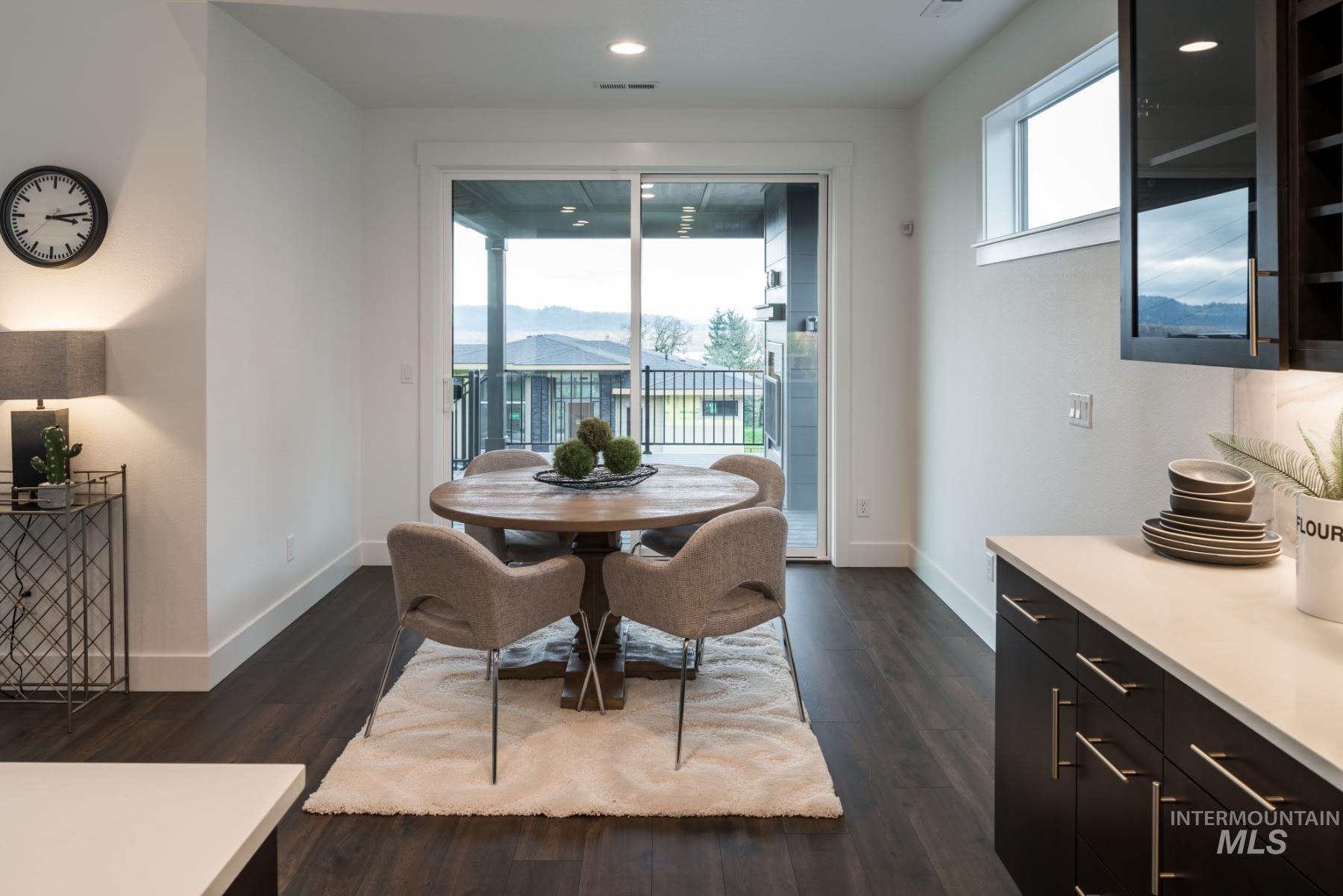 Dining space with dark wood-style floors and recessed lighting