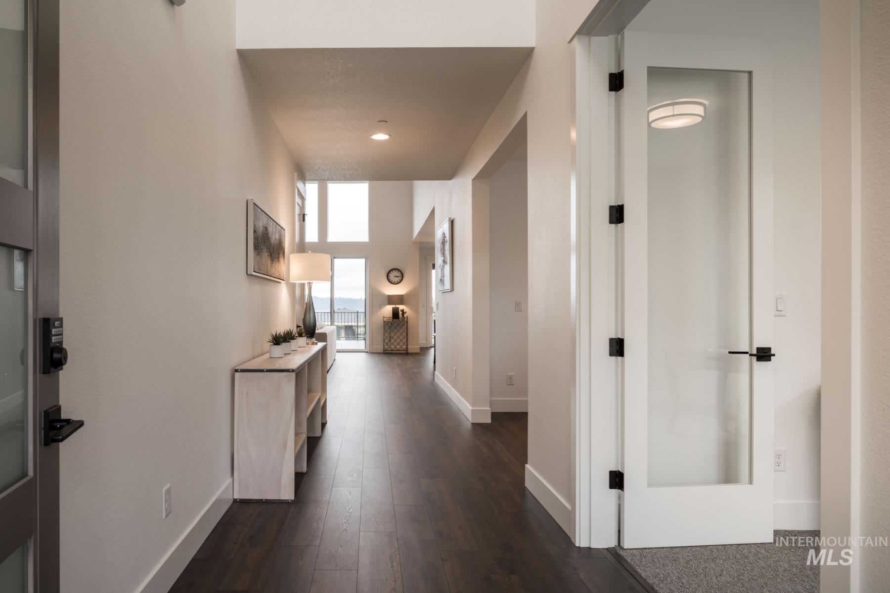 Hall featuring baseboards and dark wood finished floors