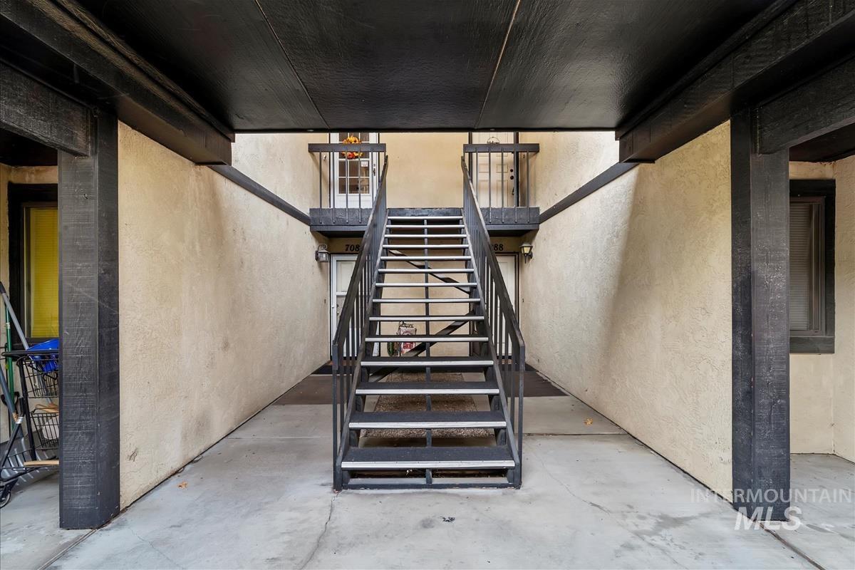 Stairway with concrete floors and a textured wall
