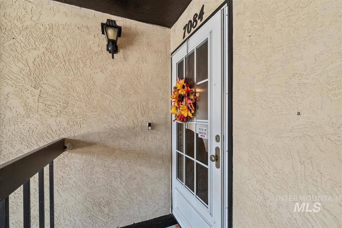 View of exterior entry featuring stucco siding