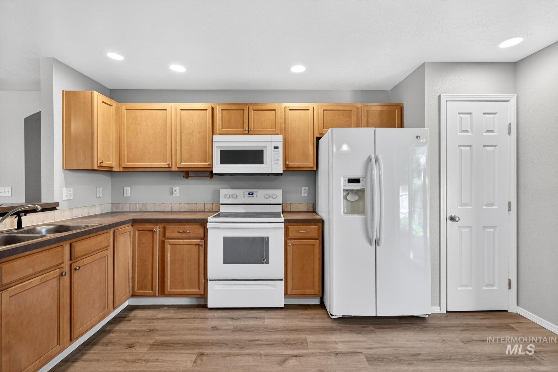 Kitchen featuring wood-finish flooring and recessed lighting