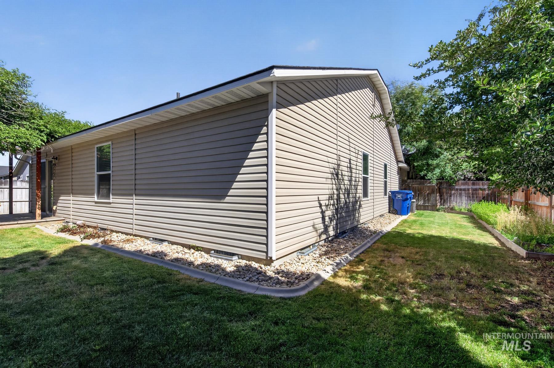 Exterior siding in a neutral tone with white trim