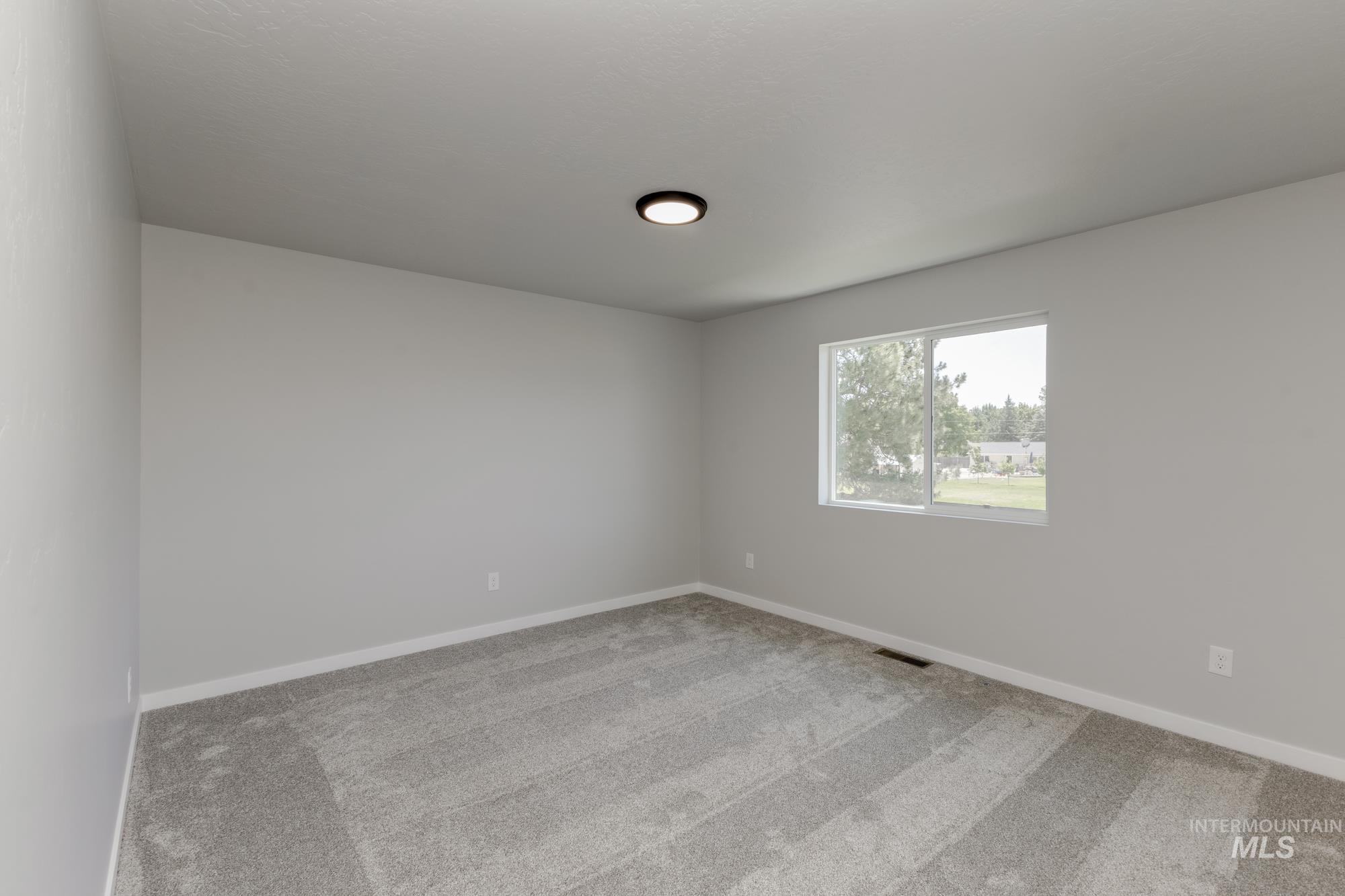 Empty room with baseboards and carpet floors