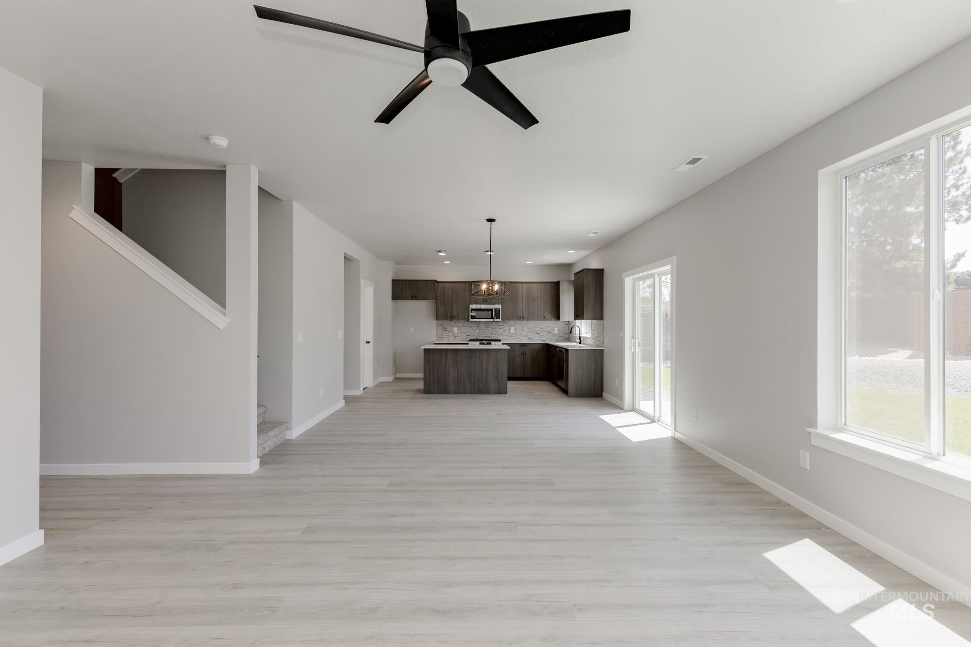 Unfurnished living room featuring plenty of natural light, light wood-style flooring, and recessed lighting