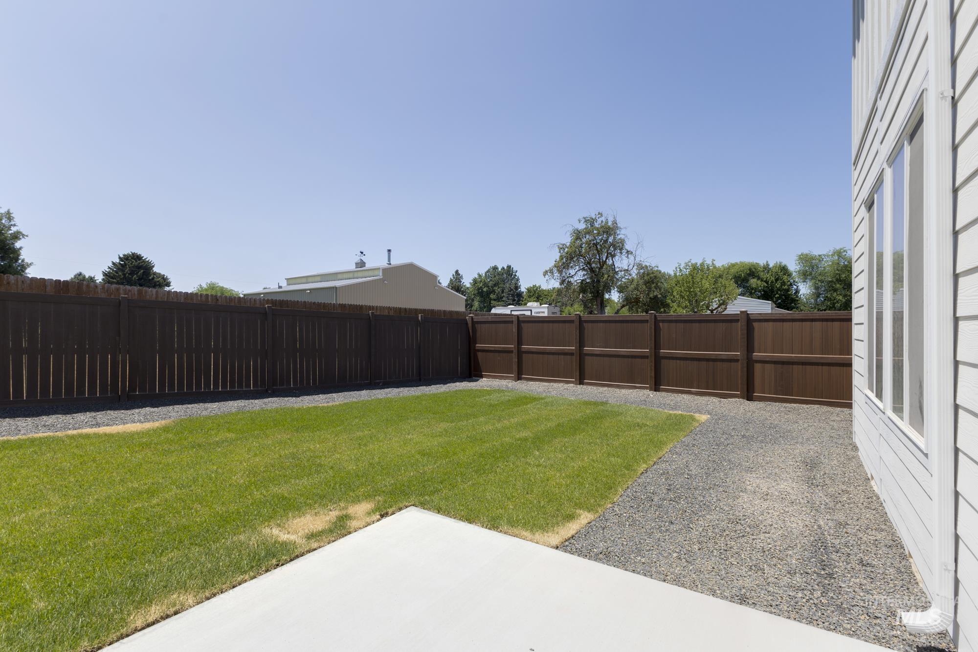 Fenced backyard featuring a patio