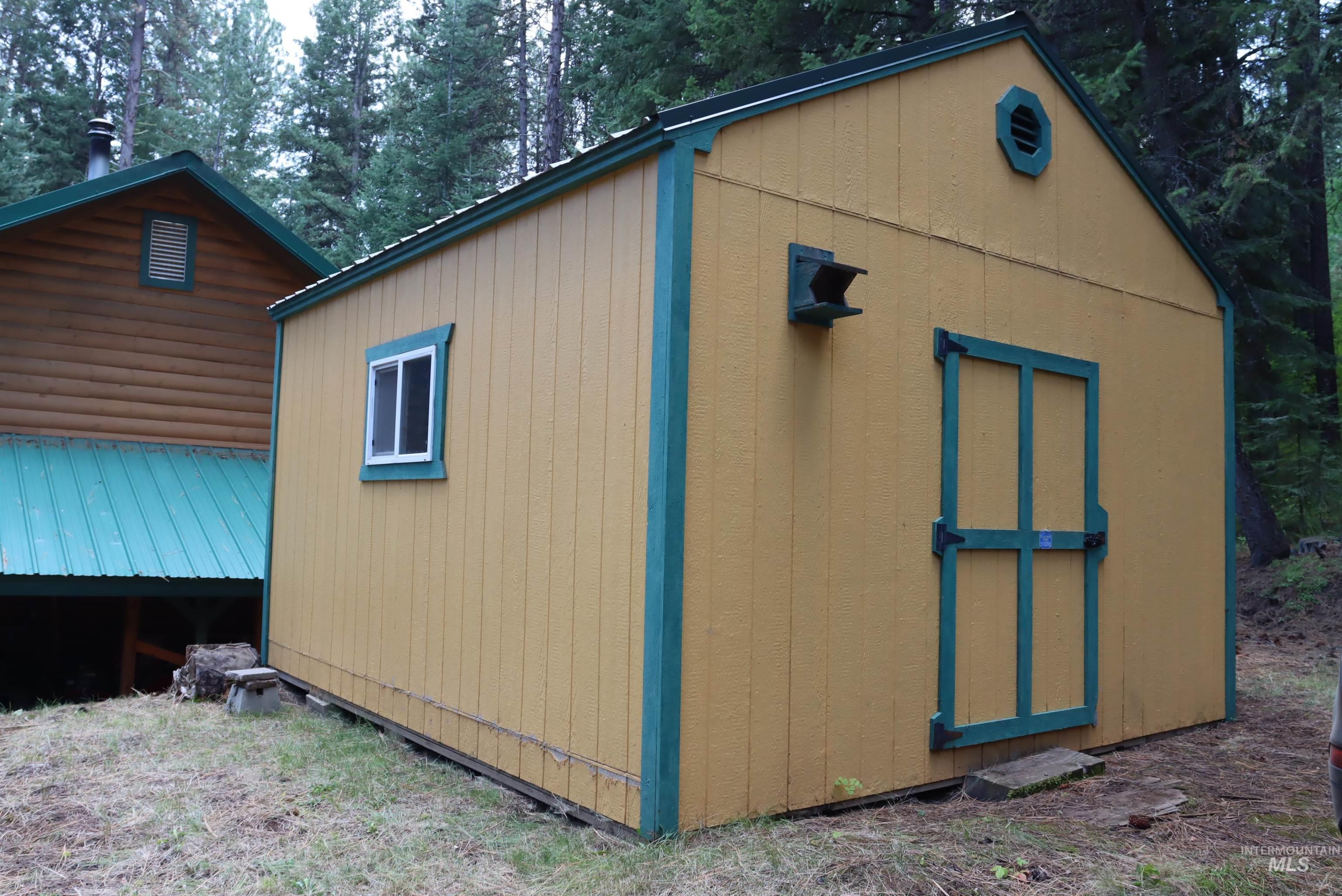 View of shed featuring view of scattered trees