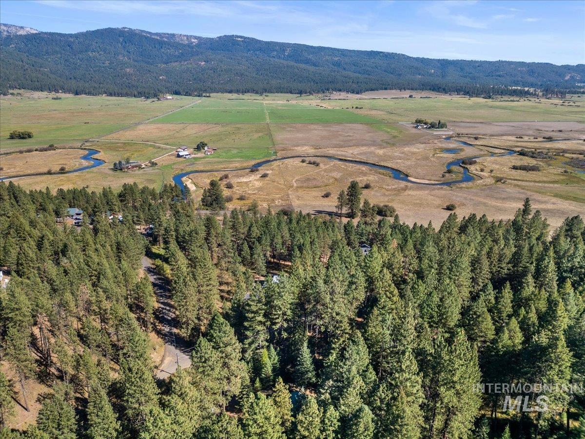Aerial view of property's location featuring a mountain backdrop and rural landscape