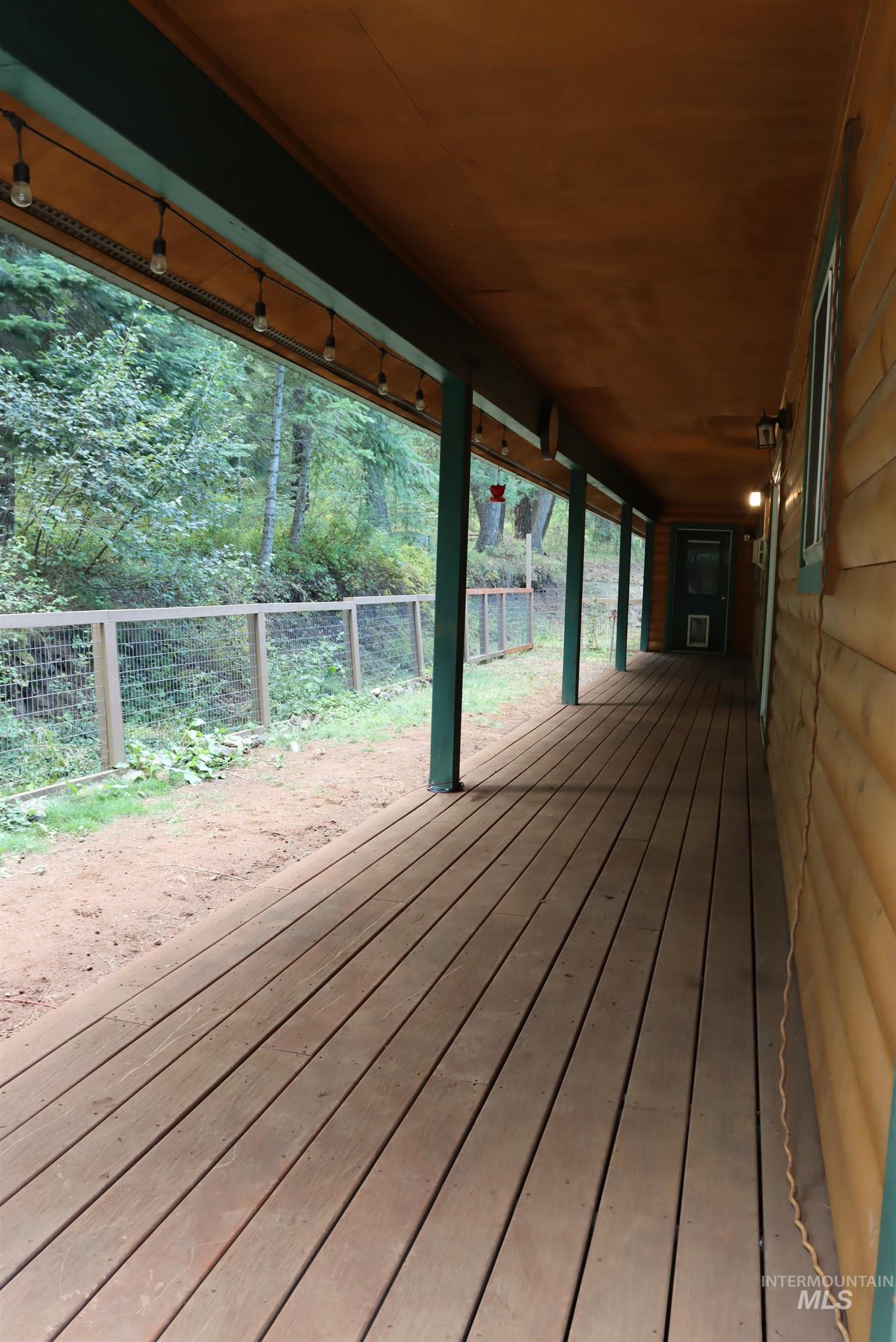 Wooden deck with a fenced backyard