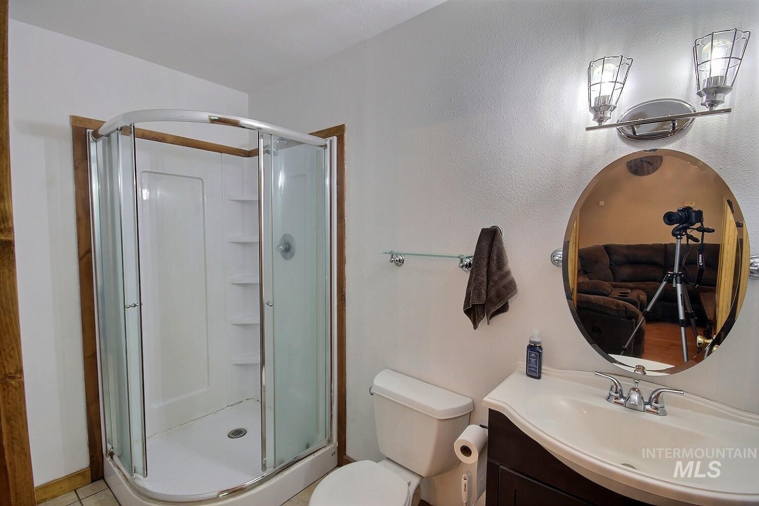 Bathroom featuring vanity, a stall shower, and tile patterned flooring