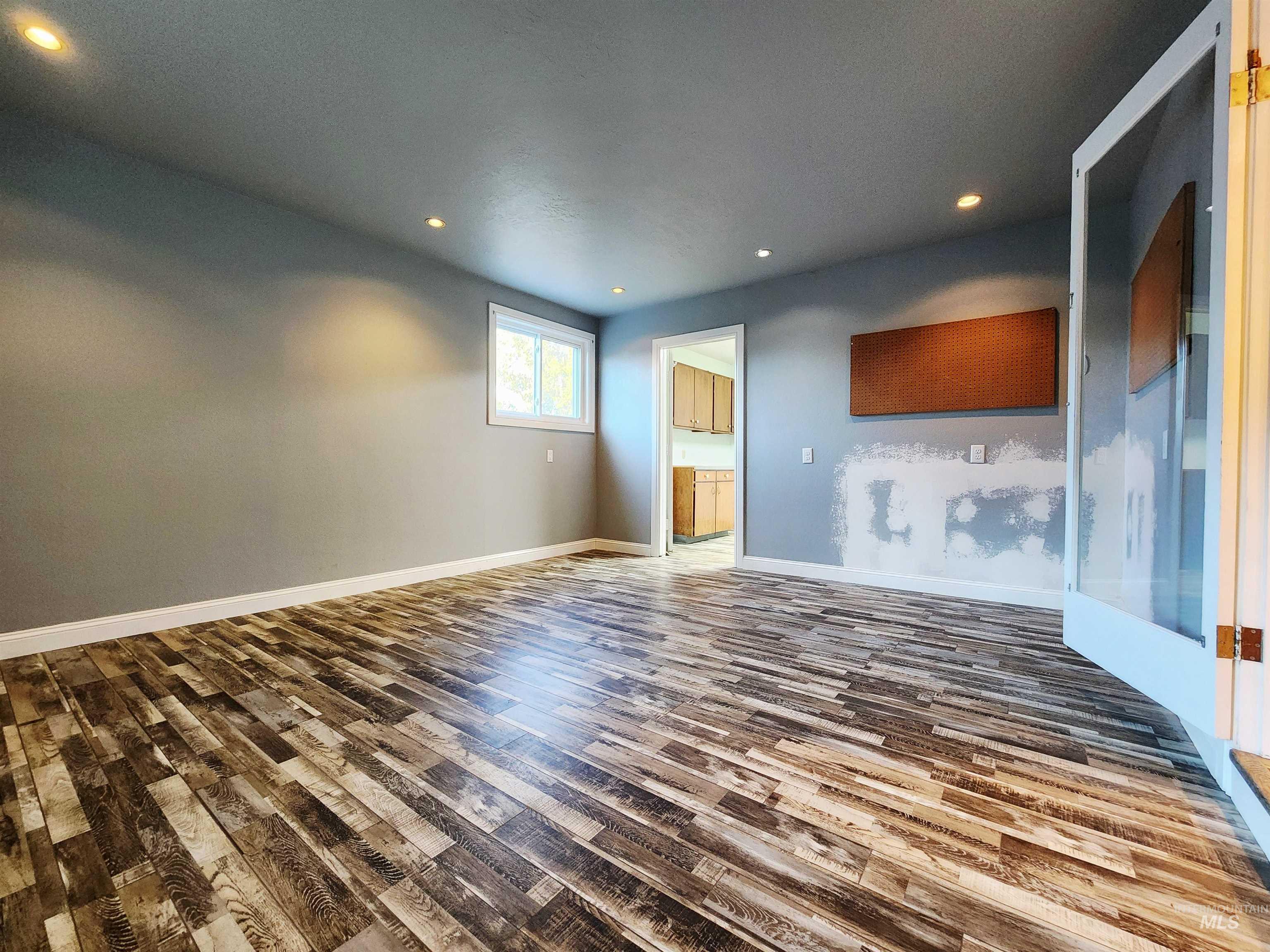 Unfurnished living room with recessed lighting and wood finished floors