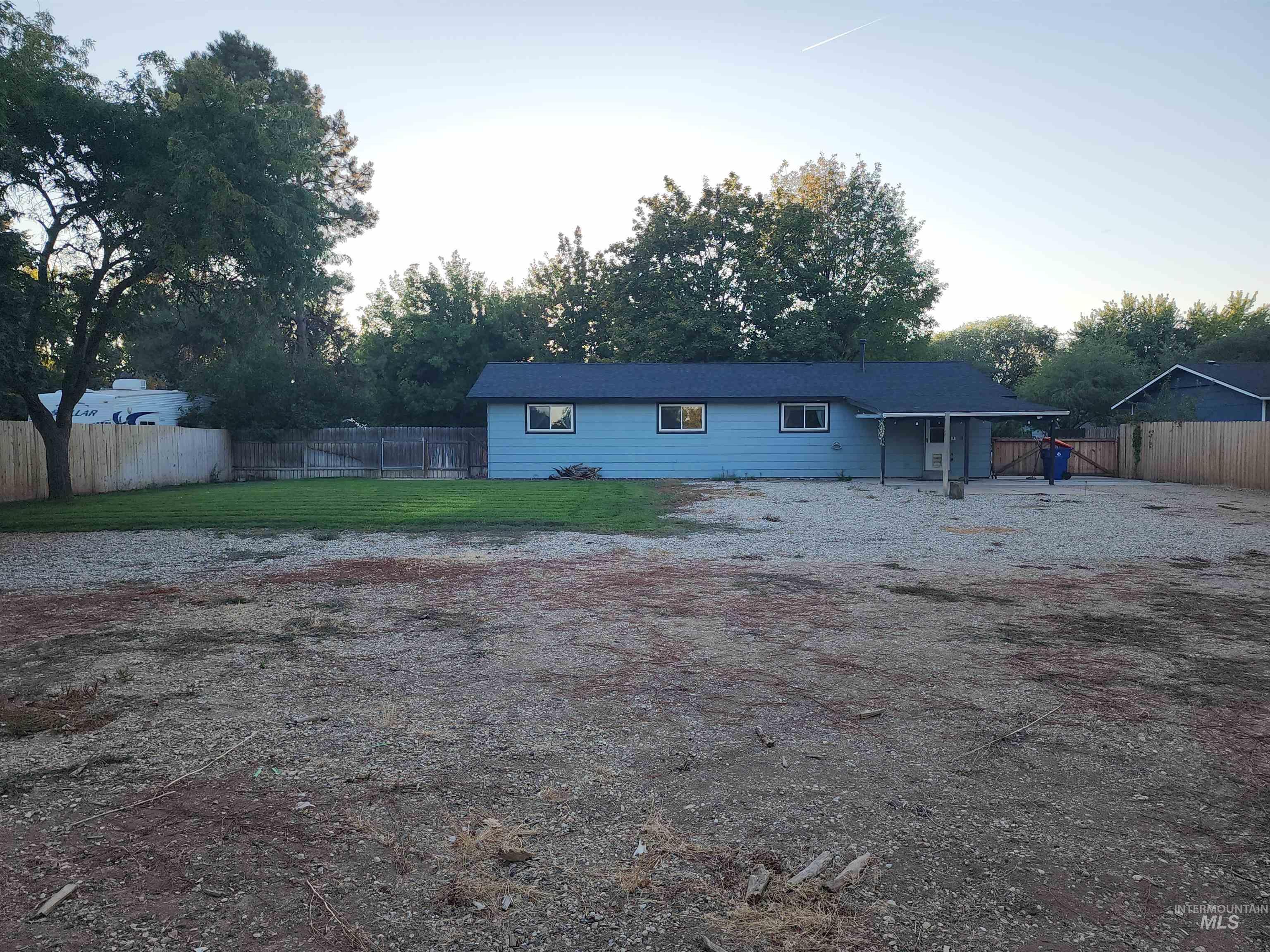 Rear view of property featuring a fenced backyard and a patio