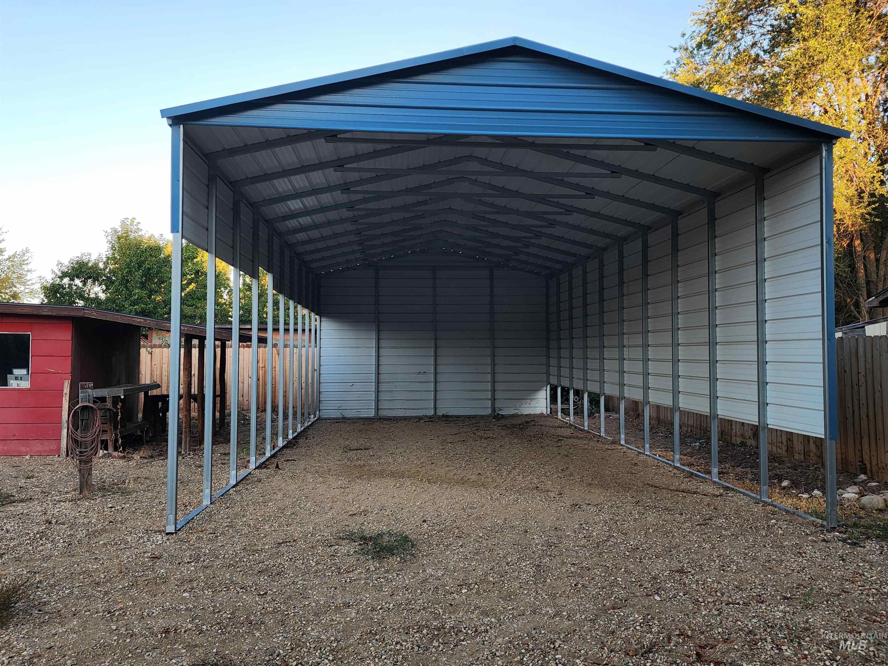 View of parking / parking lot with a detached carport