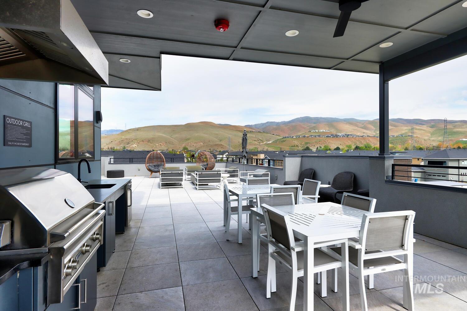 View of patio / terrace with an outdoor kitchen / dining area and a mountain view