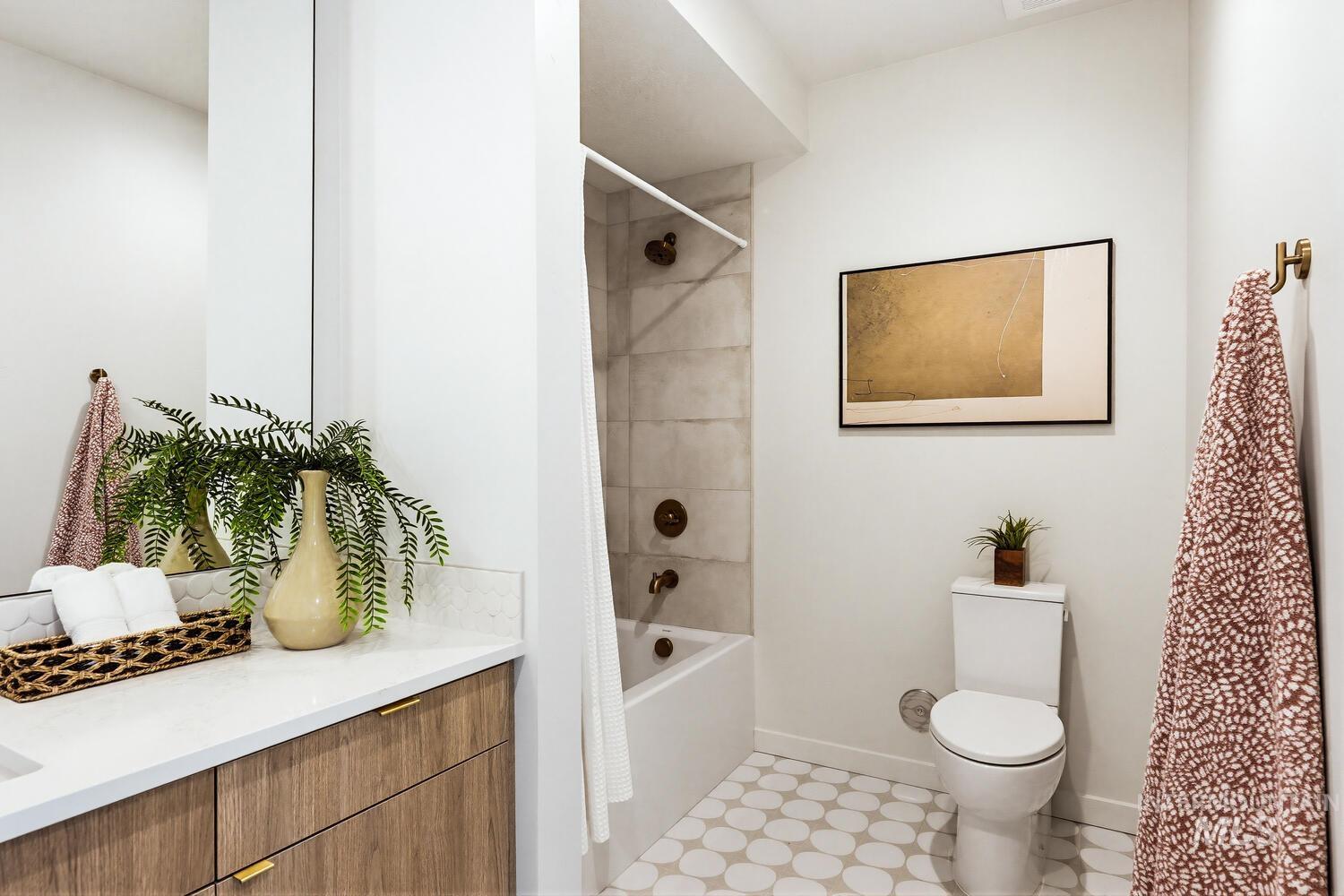 Bathroom featuring shower / bathtub combination with curtain and vanity