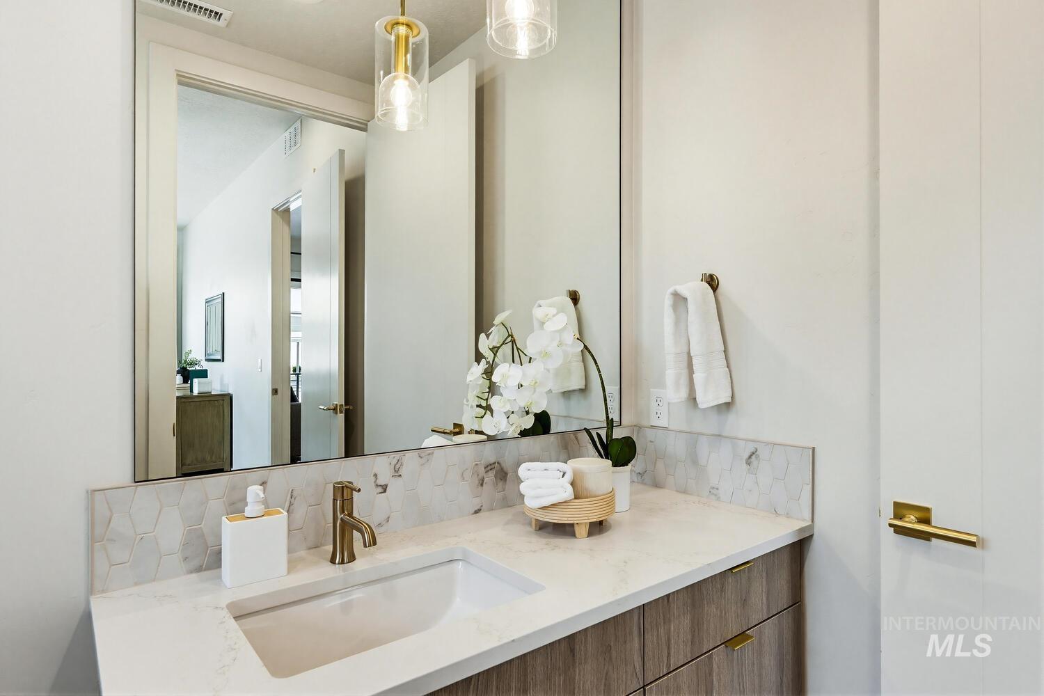 Bathroom with backsplash and vanity