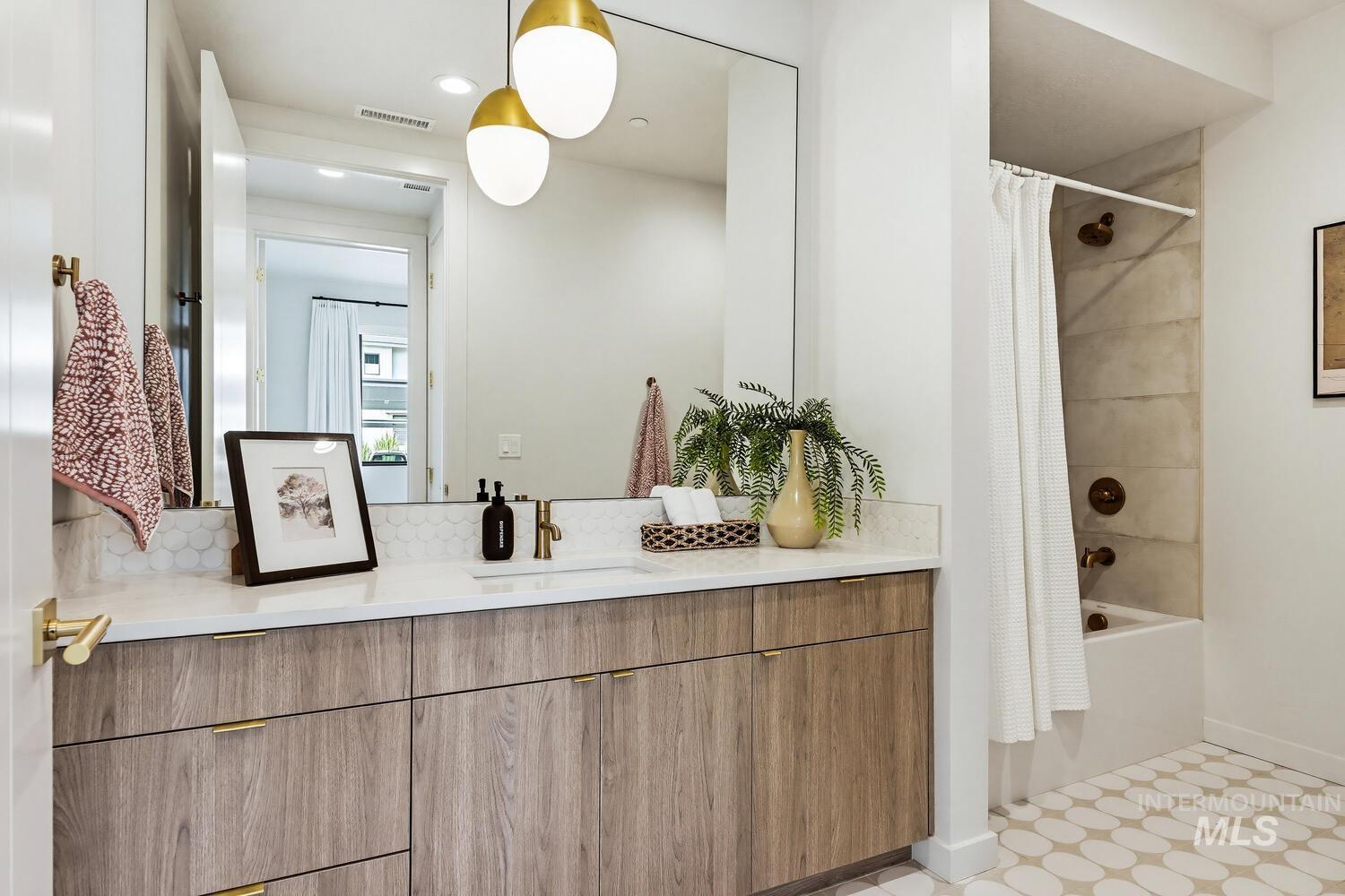 Full bathroom featuring vanity, shower / tub combo with curtain, recessed lighting, and light flooring