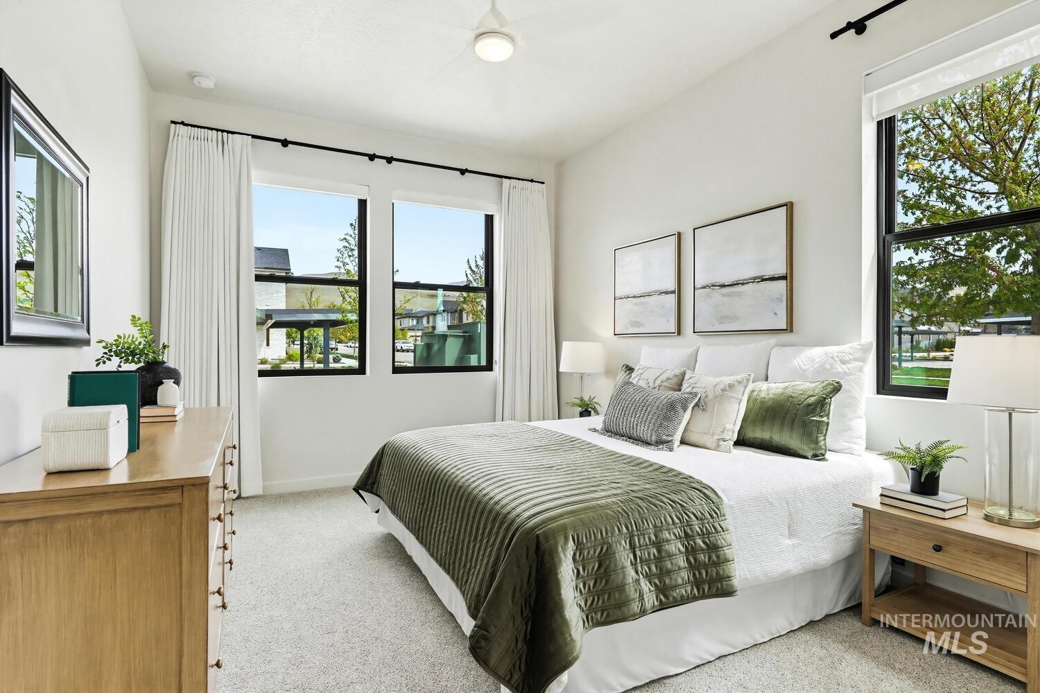 Bedroom with light colored carpet and baseboards