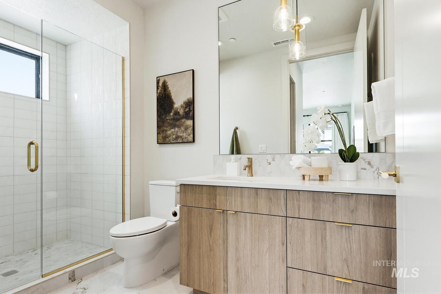 Full bath featuring vanity and a stall shower