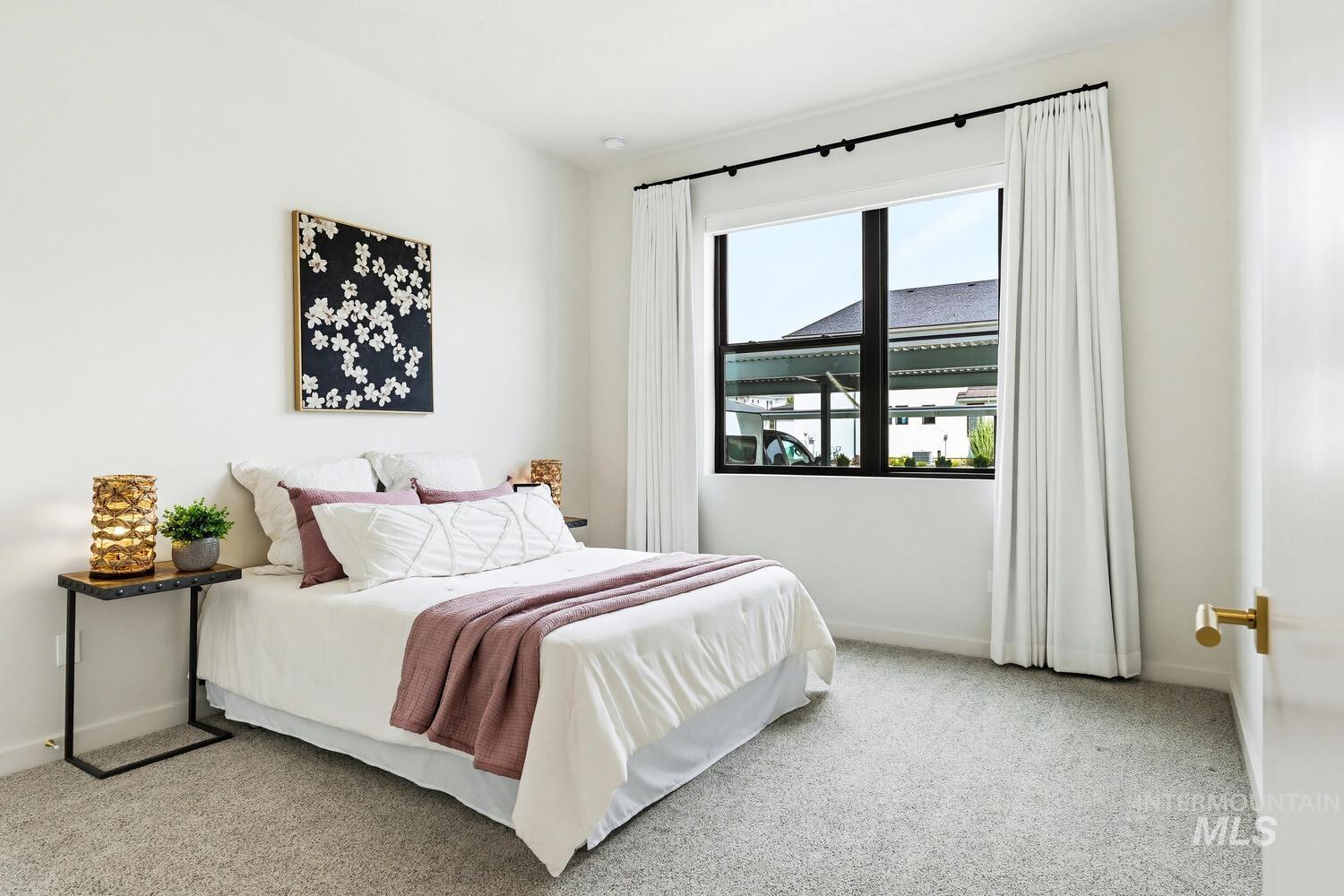 Bedroom featuring light colored carpet and baseboards