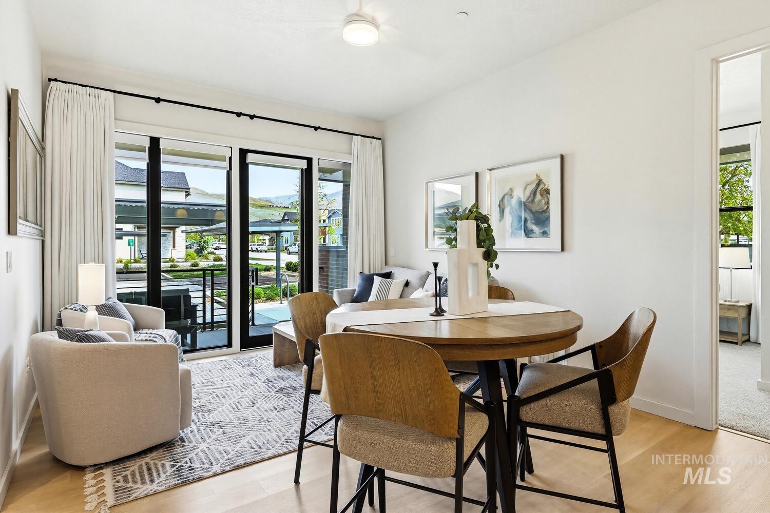 Dining space with plenty of natural light and light wood-style floors