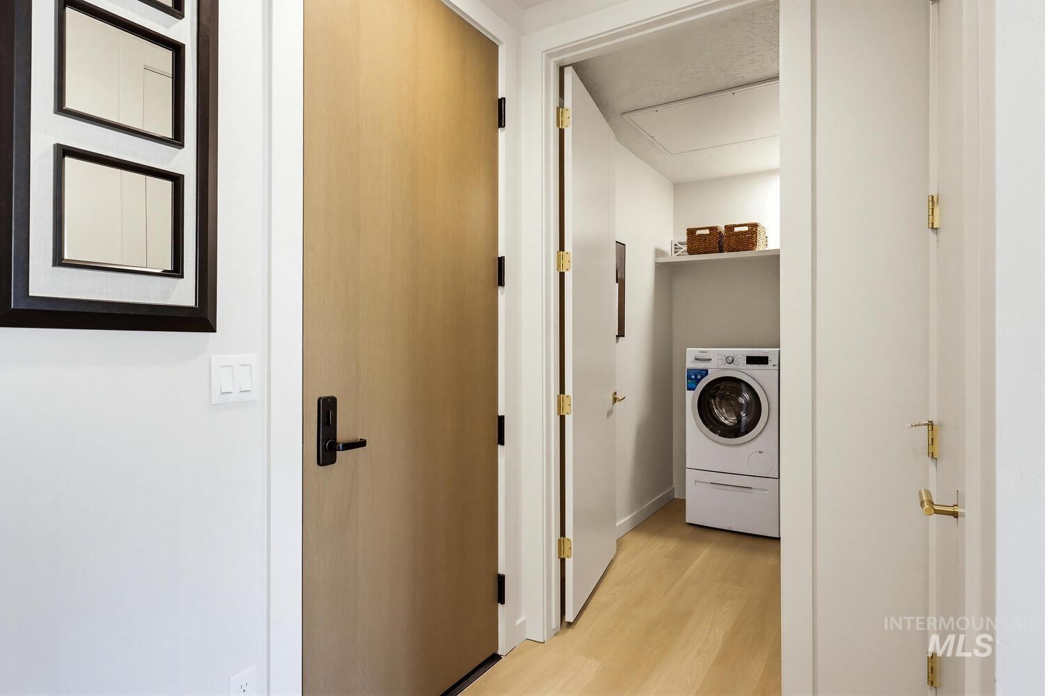 Laundry area featuring washer / clothes dryer and light wood-style floors