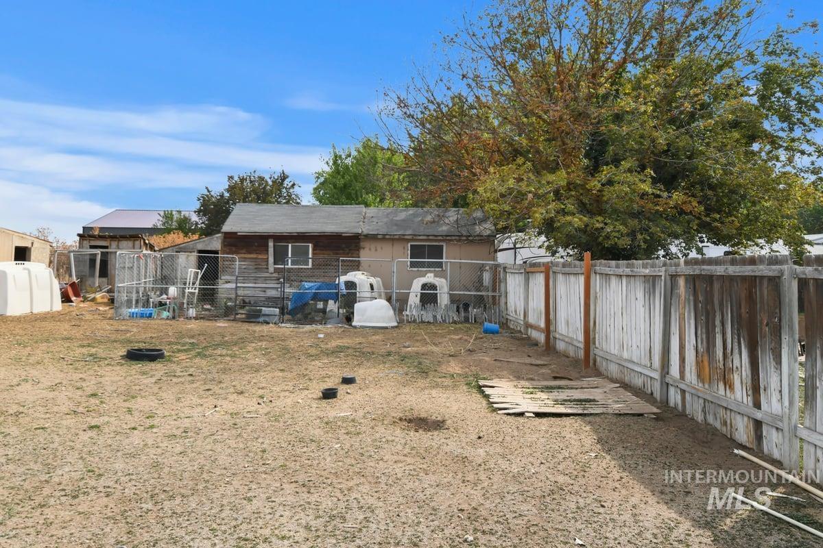 Back of house with a fenced backyard