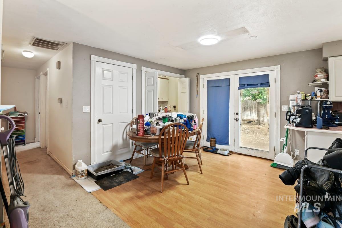 Dining area featuring light wood-style flooring and baseboards