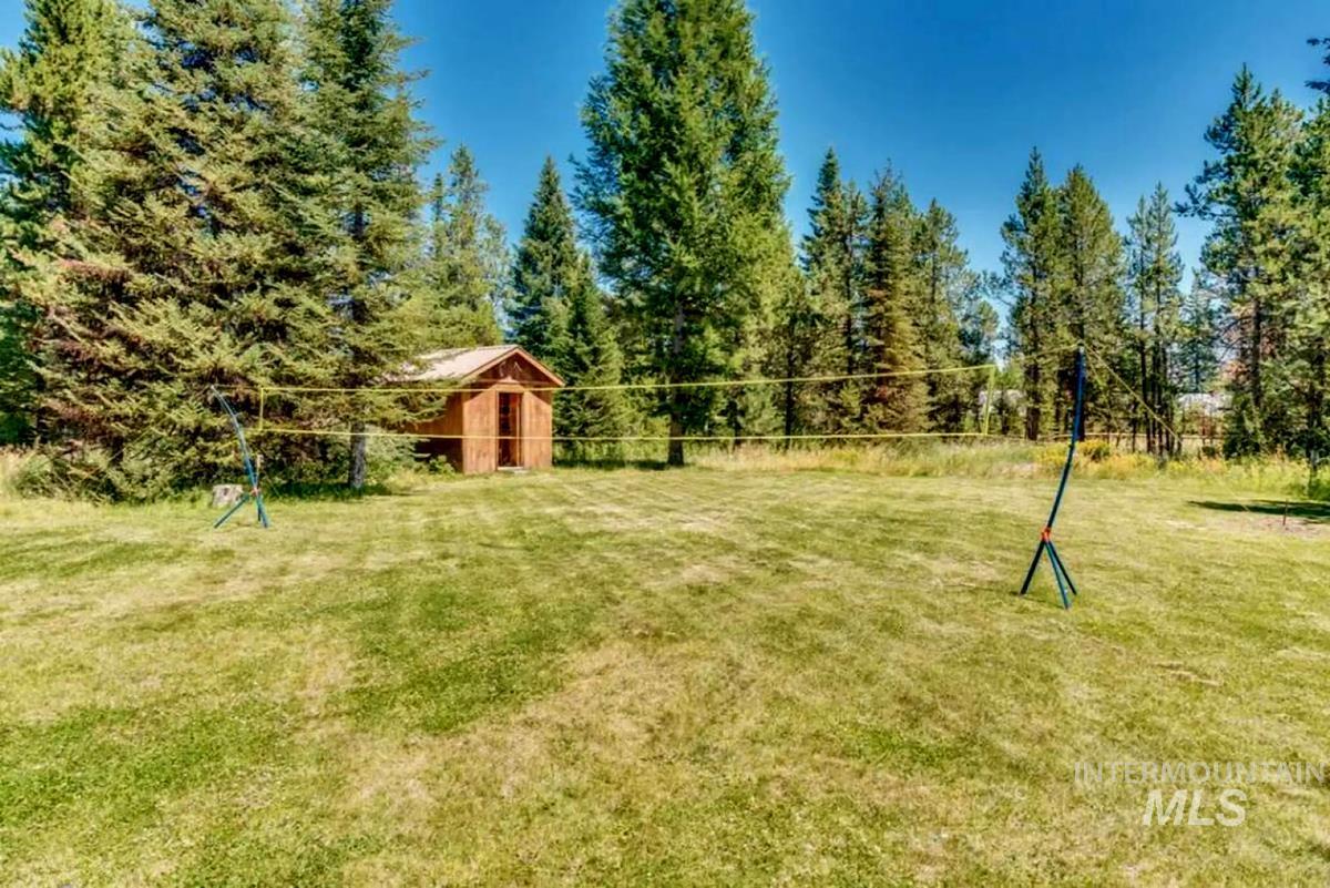 View of green lawn featuring an outbuilding