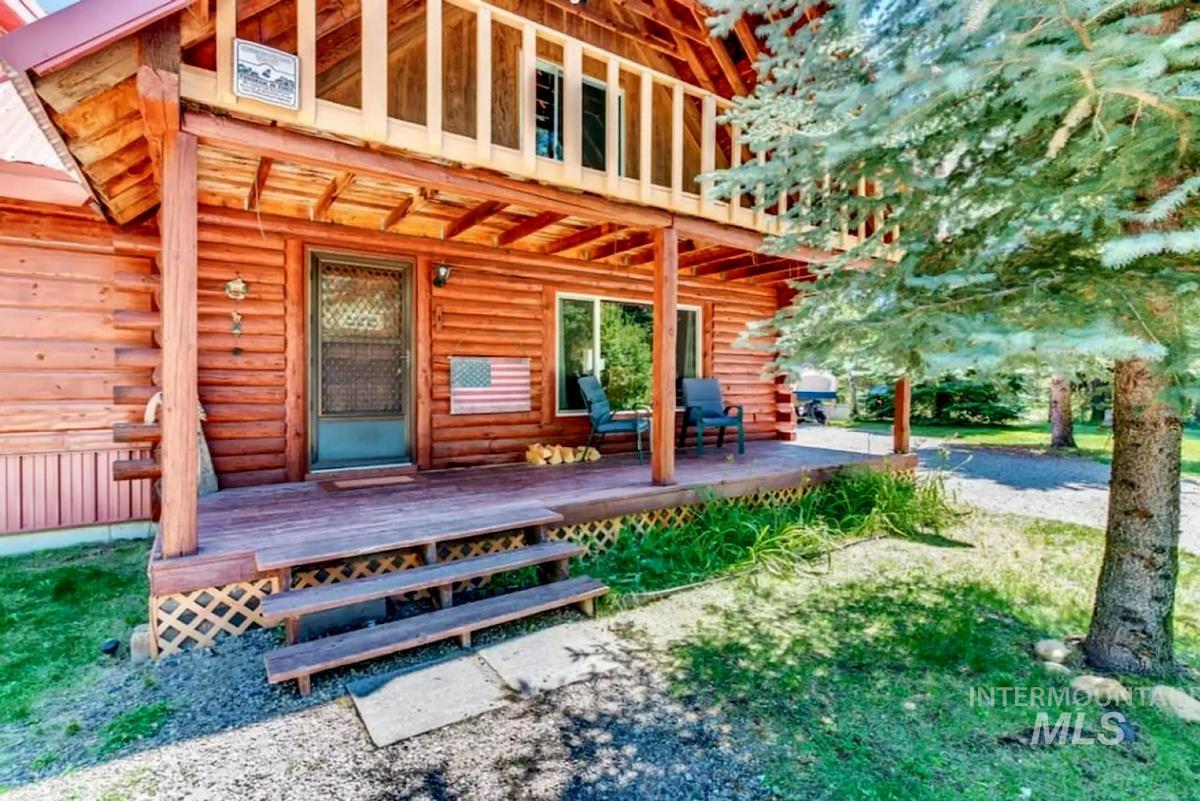 Property entrance featuring log exterior and a deck