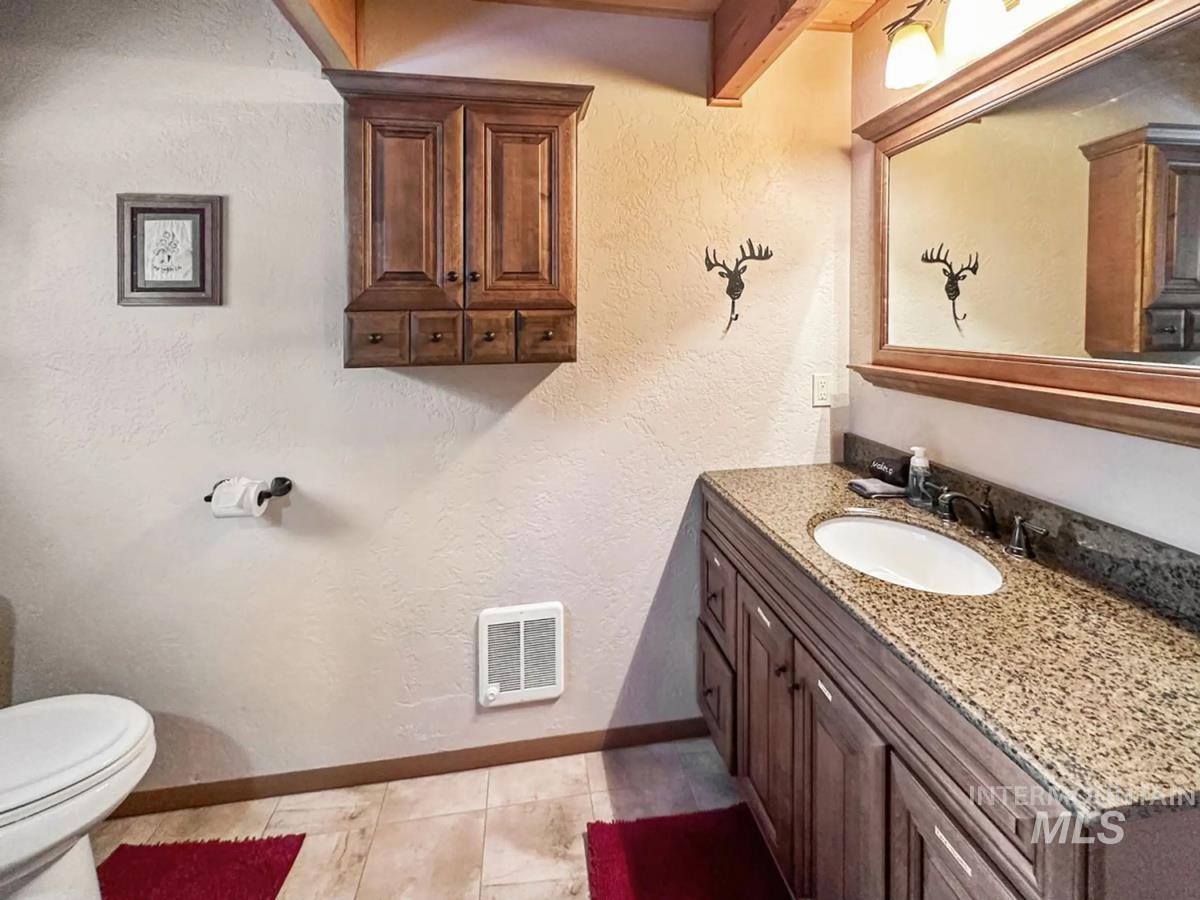 Bathroom featuring vanity and a textured wall