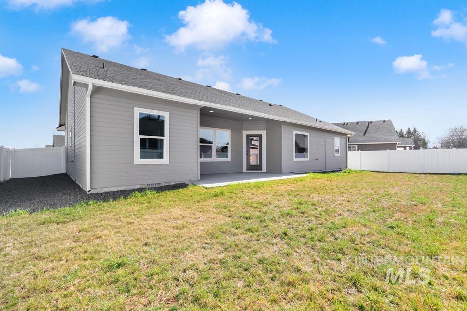 Rear view of property with a patio and a fenced backyard
