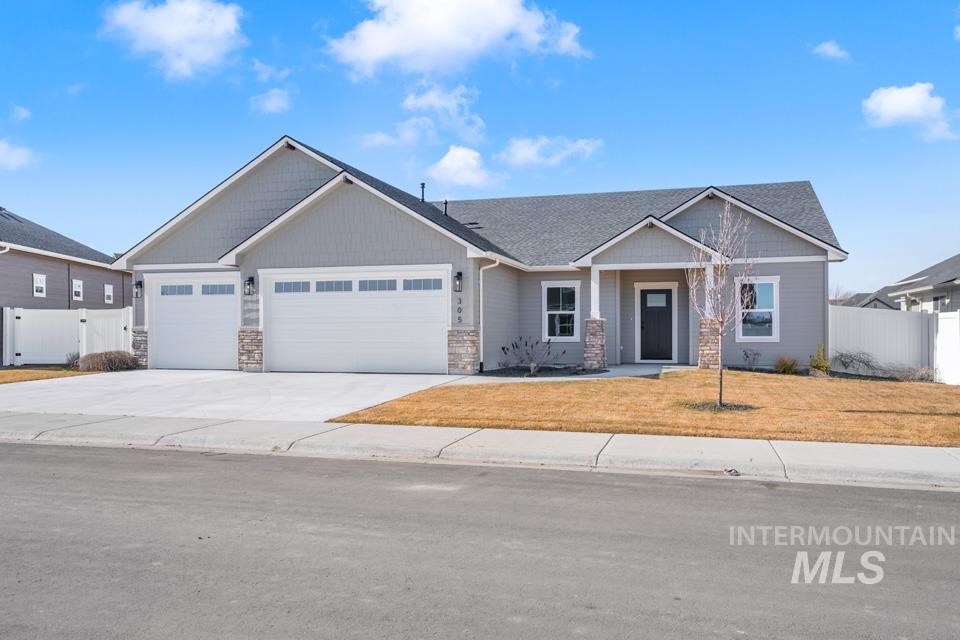 Craftsman house with an attached garage, driveway, a gate, stone siding, and a porch