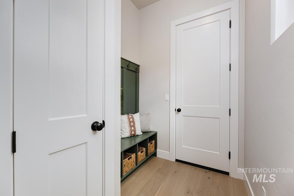 Mudroom with light wood-style floors and baseboards