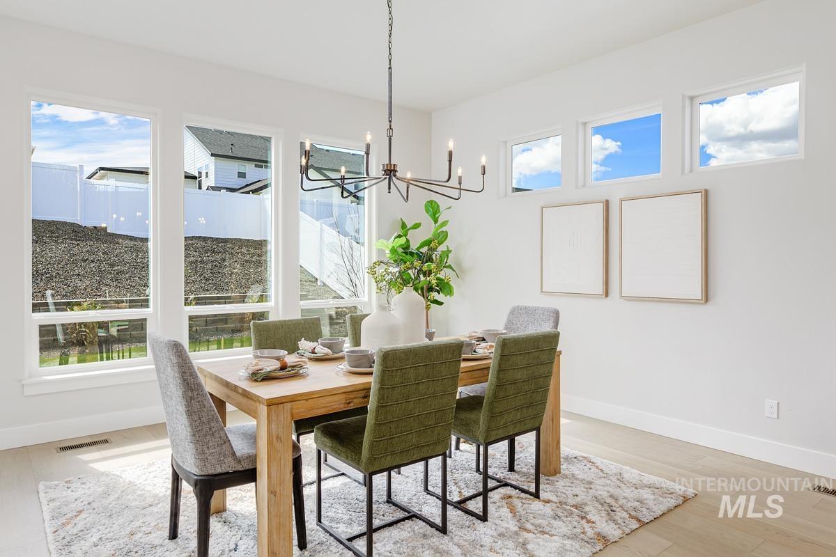 Dining area featuring a chandelier and light wood-style flooring