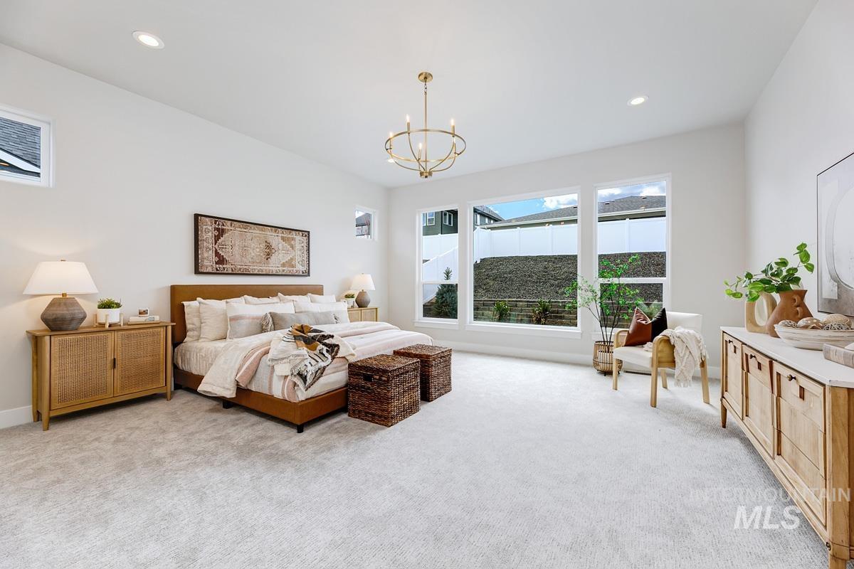 Bedroom with light carpet, recessed lighting, and a chandelier