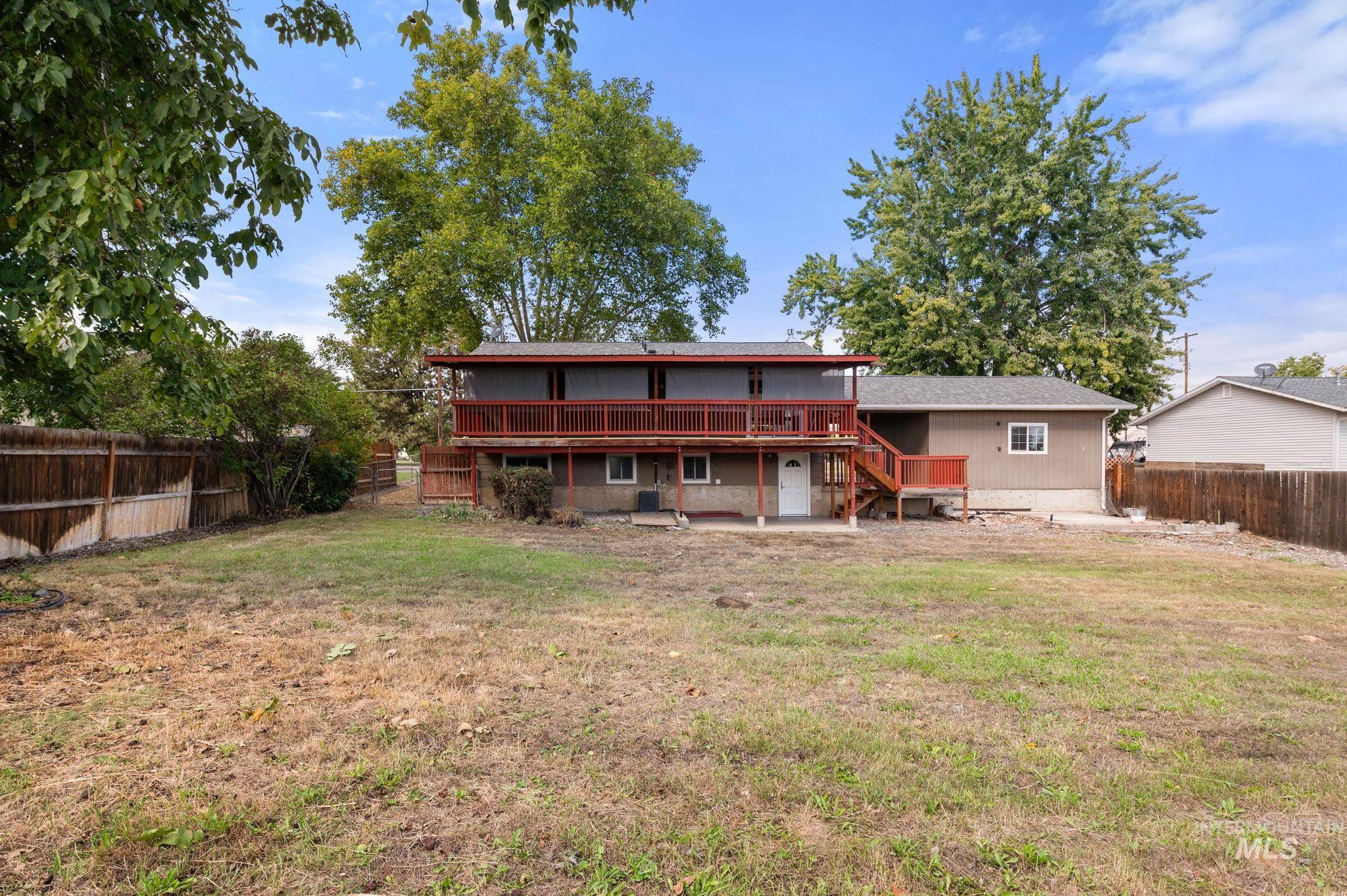 Back of house featuring a fenced backyard, stairs, and a wooden deck