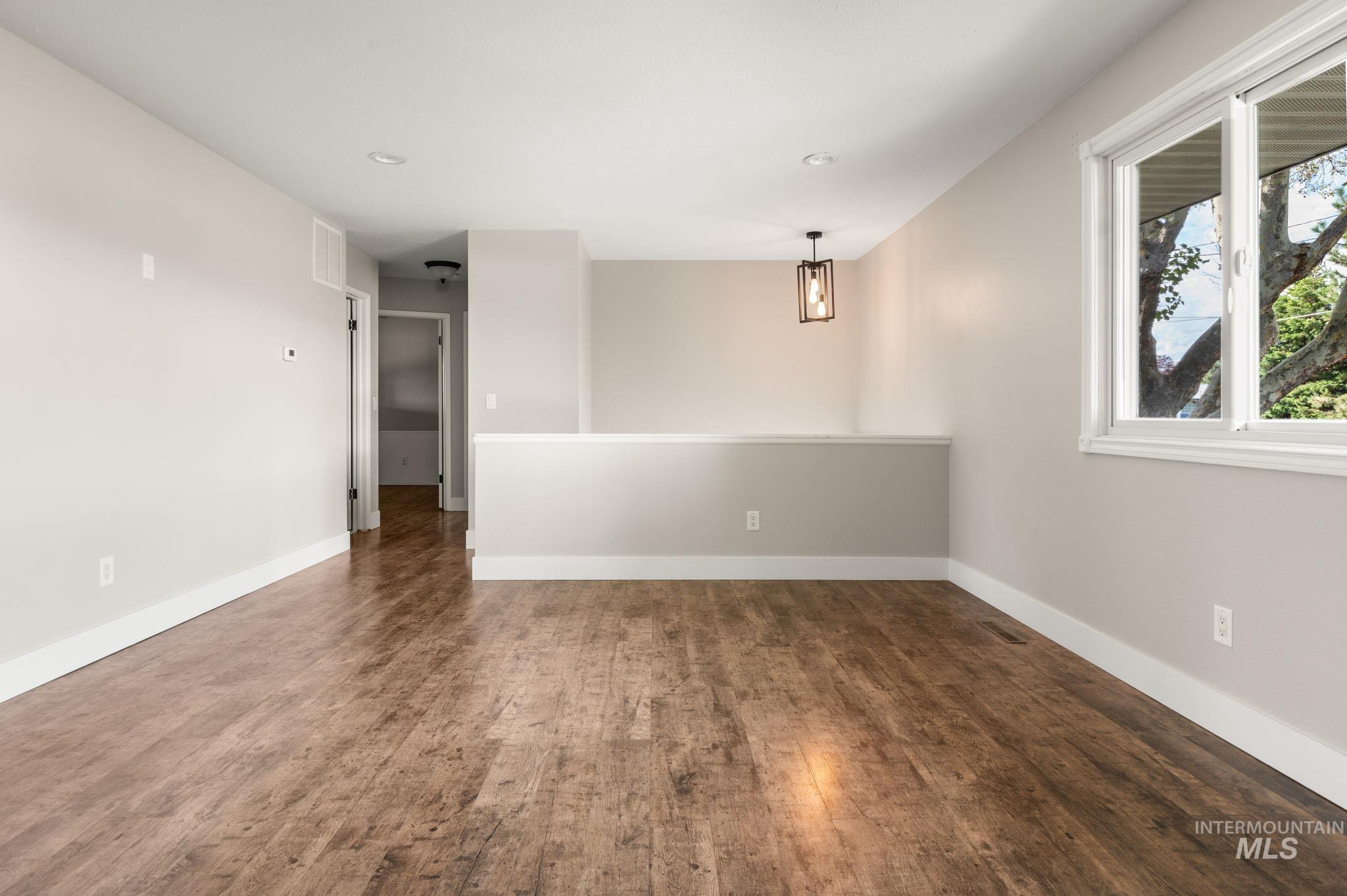 Unfurnished room featuring dark wood-style flooring and recessed lighting