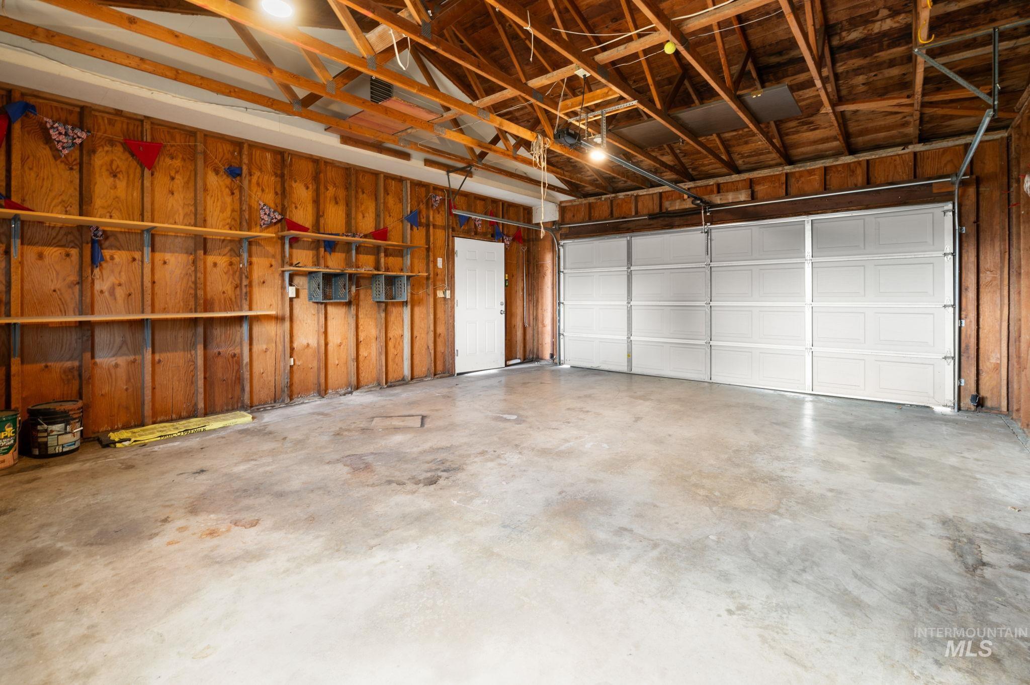 Garage featuring wooden walls