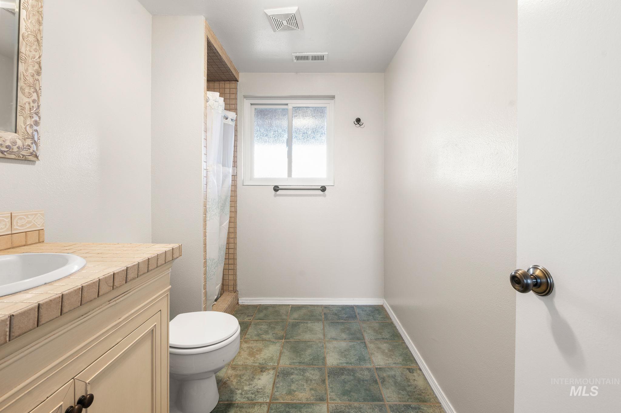 Bathroom featuring vanity and a stall shower