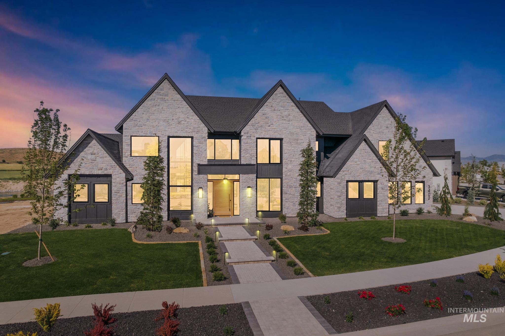 View of front of property featuring stone siding and a front yard