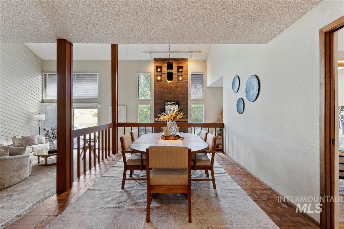Open dining area with wood-finish flooring and a central area rug