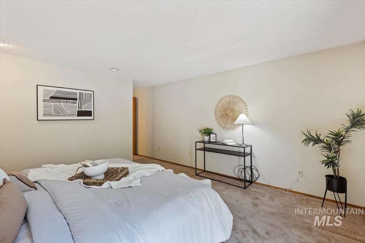 Bedroom featuring neutral-toned walls, recessed lighting, and carpeted flooring