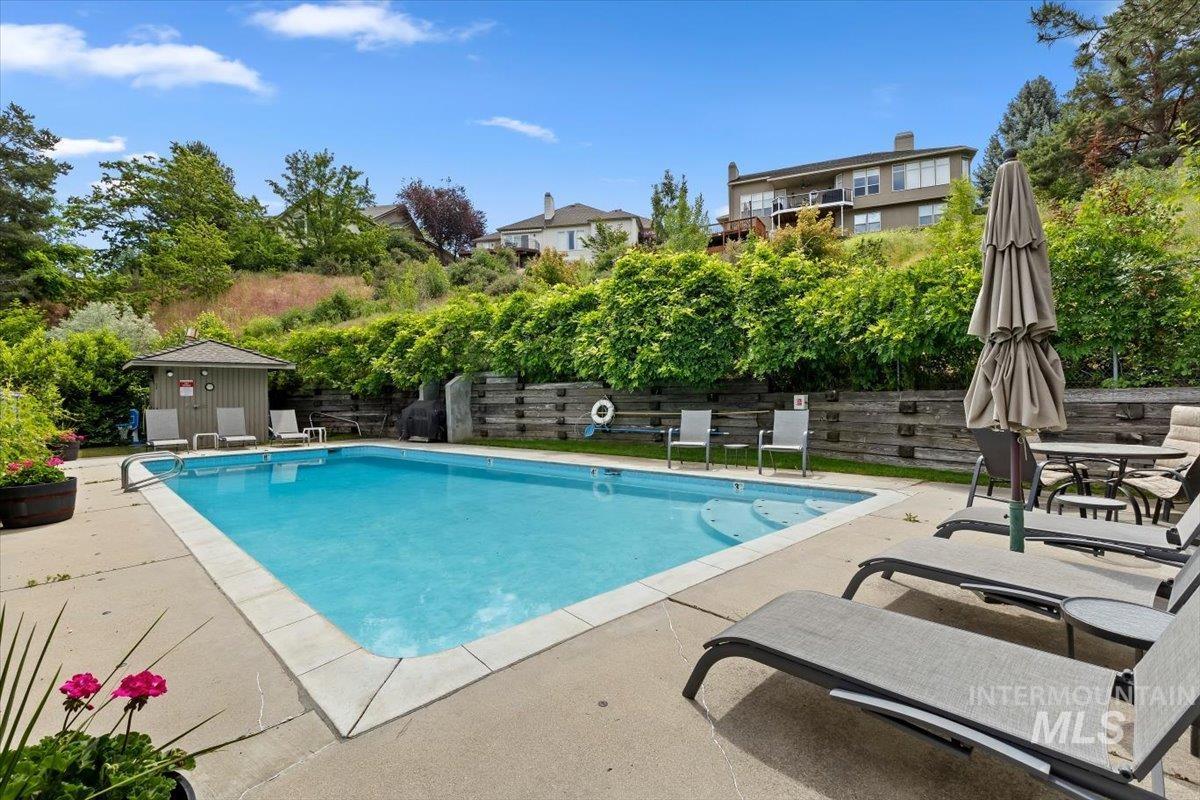 Rectangular inground swimming pool with integrated steps, surrounded by a concrete deck