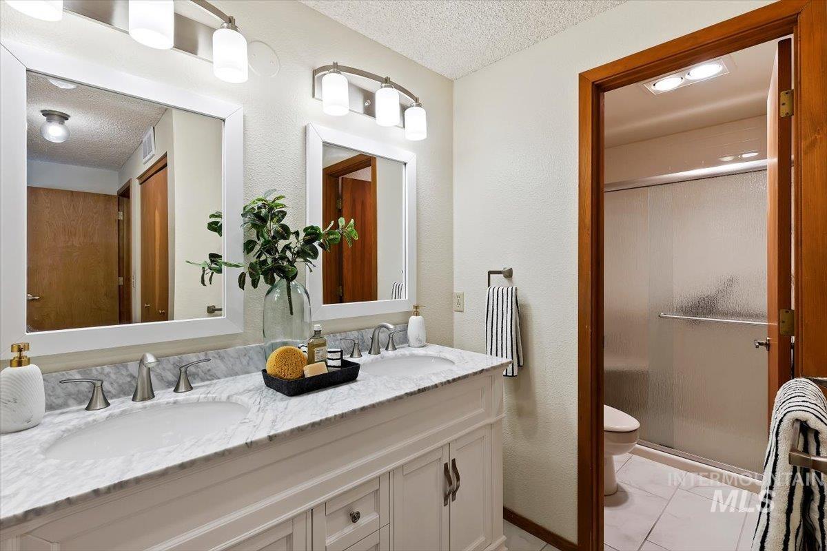 Dual vanity with stone countertop and undermount sinks